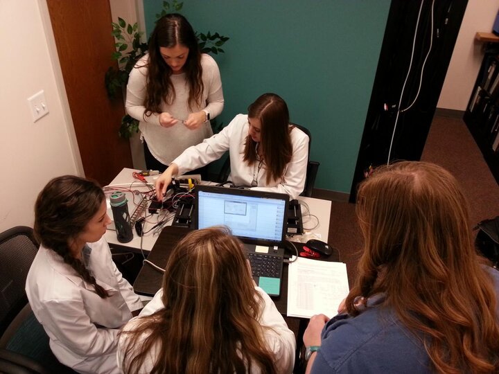 Students working around a computer